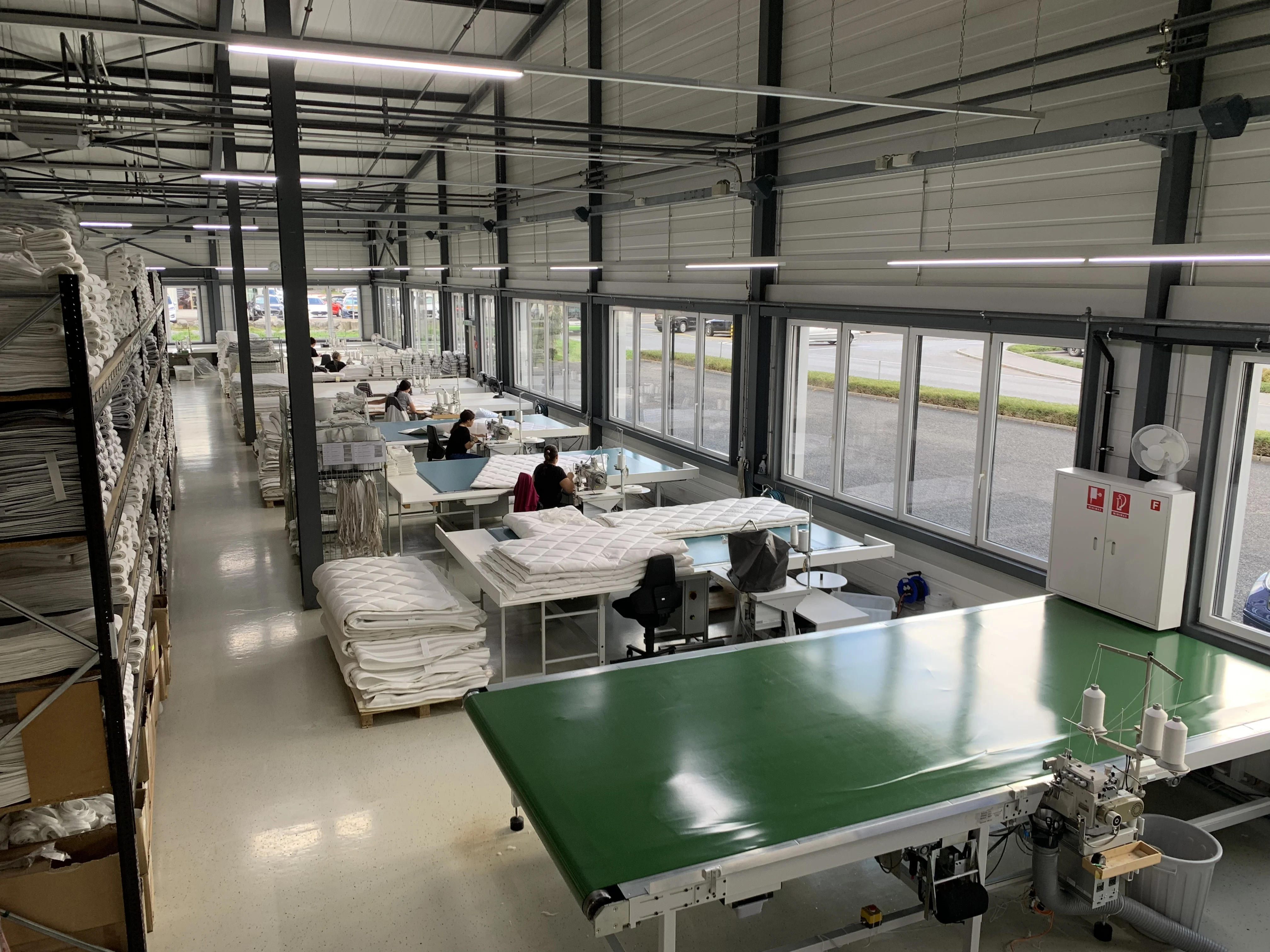 Moderne Industriebeleuchtung in einer Produktionshalle mit Tulux Leuchten.